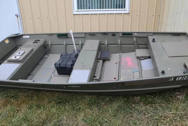 Slide: The Image of 2020 Lowe 1448T aluminum boat on grass, near a beige building. - 1