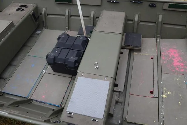 Slide: The Image of Interior of a 2020 Lowe 1448T boat with storage compartments and battery box. - 2