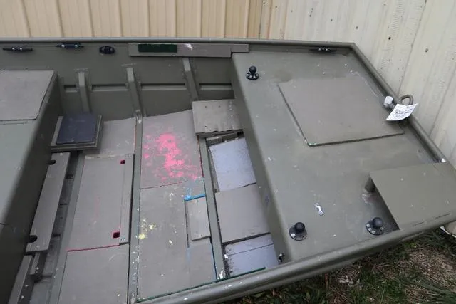 Slide: The Image of 2020 Lowe 1448T boat interior with storage compartments and seating. - 4