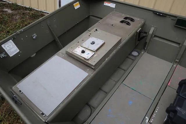 Slide: The Image of 2020 Lowe 1448T boat interior with storage compartments and seating. - 5