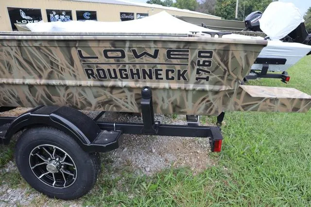Slide: The Image of 2025 Lowe Roughneck 1760 Tiller boat with camouflage design on a trailer. - 3