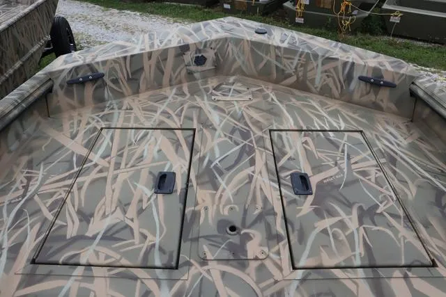Slide: The Image of 2025 Lowe Roughneck 1760 Tiller boat with camouflage design and storage compartments. - 8