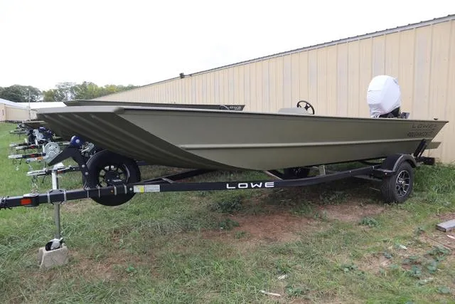 Slide: The Image of 2025 Lowe Roughneck 1860 Rambler boat on trailer, parked outdoors. - 1