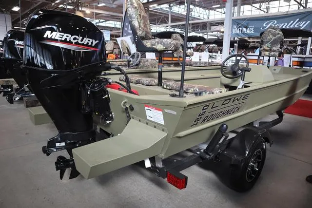Slide: The Image of 2025 Lowe Roughneck 1860 Rambler boat with Mercury engine displayed indoors. - 15