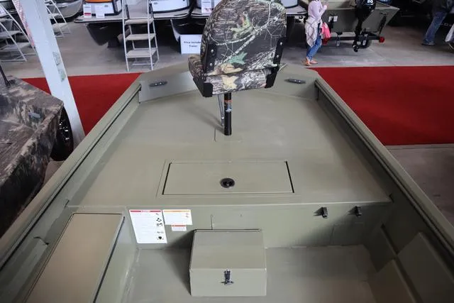 Slide: The Image of 2025 Lowe Roughneck 1860 Rambler boat interior with camo seat and storage compartments. - 16
