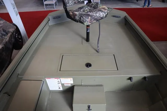 Slide: The Image of 2025 Lowe Roughneck 1860 Rambler boat interior with camo seat and storage compartments. - 18