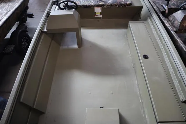 Slide: The Image of 2025 Lowe Roughneck 1860 Rambler boat interior, featuring spacious layout and steering console. - 20