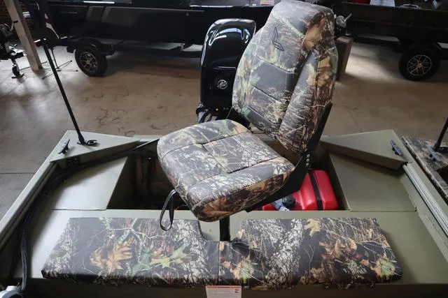 Slide: The Image of 2025 Lowe Roughneck 1860 Rambler boat with camo seating in a showroom. - 23