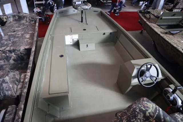 Slide: The Image of 2025 Lowe Roughneck 1860 Rambler boat interior with steering wheel and camouflage seating. - 24