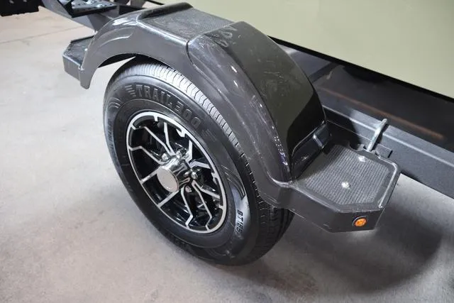 Slide: The Image of 2025 Lowe Roughneck 1860 Rambler trailer wheel with black fender and step. - 25