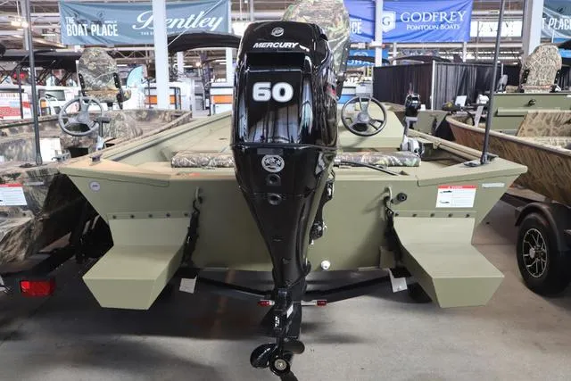 Slide: The Image of 2025 Lowe Roughneck 1860 Rambler boat with Mercury 60 engine, displayed indoors. - 27