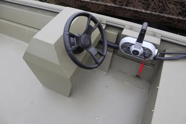 Slide: The Image of Steering console of 2025 Lowe Roughneck 1860 Rambler boat, featuring a simple design. - 3