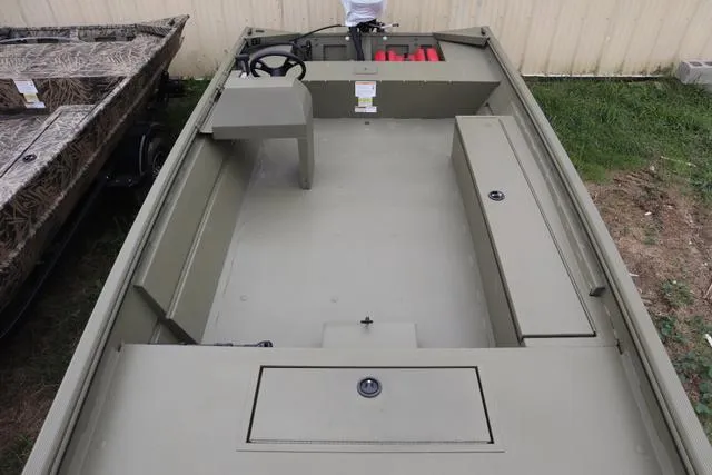 Slide: The Image of 2025 Lowe Roughneck 1860 Rambler boat interior, featuring spacious seating and storage compartments. - 8