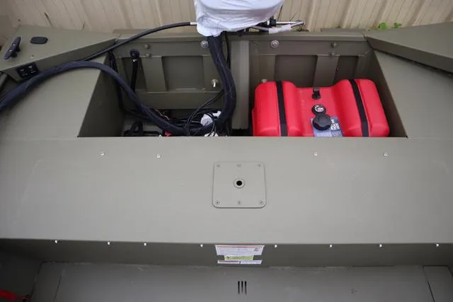 Slide: The Image of 2025 Lowe Roughneck 1860 Rambler boat interior with red fuel tank and wiring. - 9