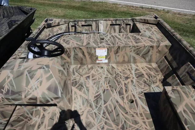 Slide: The Image of 2025 Lowe Roughneck 1760 boat with camo design and add-on console. - 4