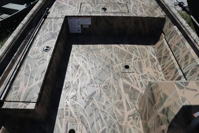 Slide: The Image of 2025 Lowe Roughneck 1760 boat interior with camo pattern and add-on console. - 8