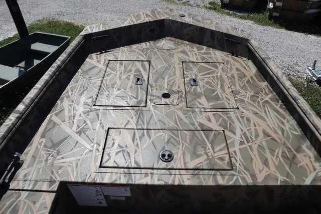 Slide: The Image of 2025 Lowe Roughneck 1760 boat deck with camo pattern and storage compartments. - 9