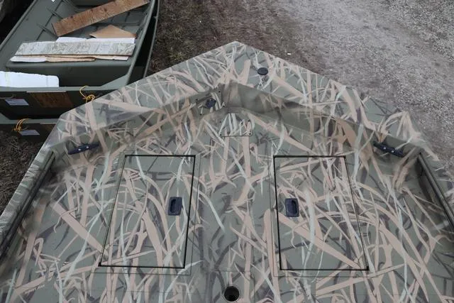 Slide: The Image of Camouflage-patterned Lowe 2070 boat deck with storage compartments, 2025 model. - 10