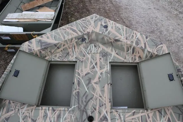 Slide: The Image of Camouflage-patterned Lowe 2070 boat with open storage compartments, 2025 model. - 11