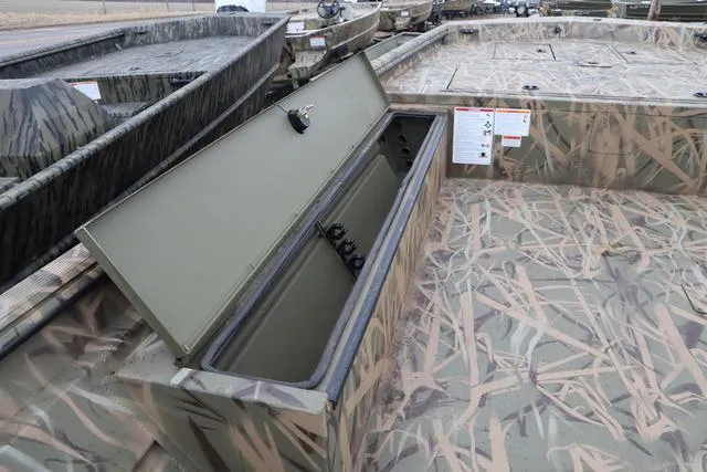 Slide: The Image of 2025 Lowe 2070 boat with add-on console, featuring camo design and open storage compartment. - 13