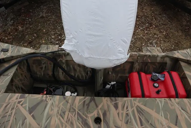 Slide: The Image of Lowe 2070 boat interior with camo design, red fuel tank, and covered console, 2025 model. - 16