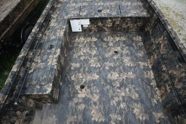 Slide: The Image of 2024 Lowe Roughneck 1660 Tiller boat interior with camouflage pattern flooring. - 4