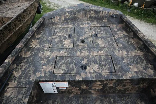 Slide: The Image of 2024 Lowe Roughneck 1660 Tiller boat with camouflage interior design. - 6