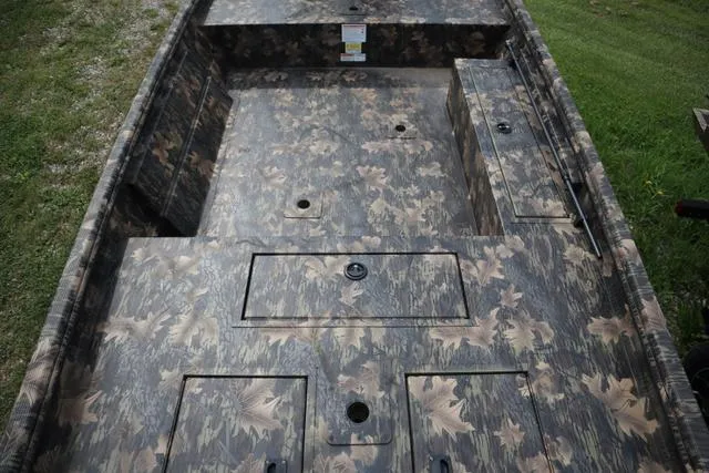 Slide: The Image of 2024 Lowe Roughneck 1660 Tiller boat interior with camouflage design. - 7