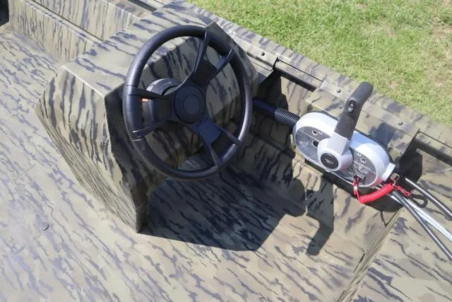 Slide: The Image of 2025 Lowe Roughneck 1860 Add-On Console with steering wheel and controls, camo design. - 4