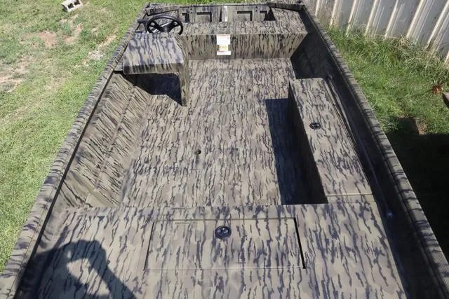 Slide: The Image of 2025 Lowe Roughneck 1860 Add-On Console boat with camouflage interior design. - 6