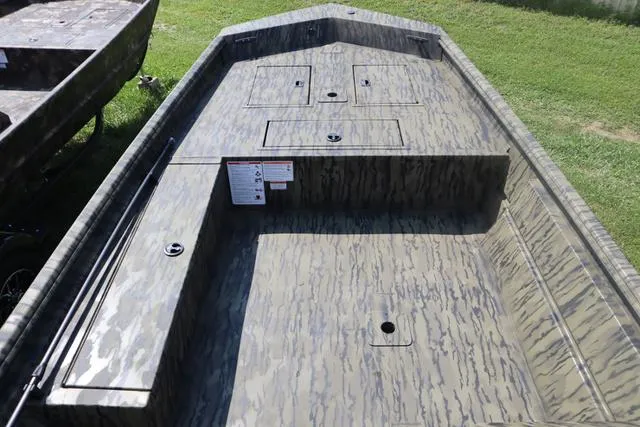 Slide: The Image of 2025 Lowe Roughneck 1860 Add-On Console boat with camouflage design on grass. - 7