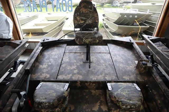 Slide: The Image of 2024 Lowe Roughneck 1760 SC Jet boat interior with camouflage seating and deck. - 5