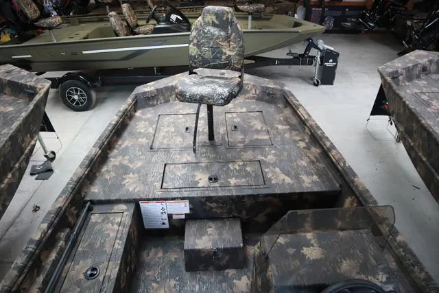 Slide: The Image of 2024 Lowe Roughneck 1760 SC Jet boat with camouflage seating and storage compartments. - 7