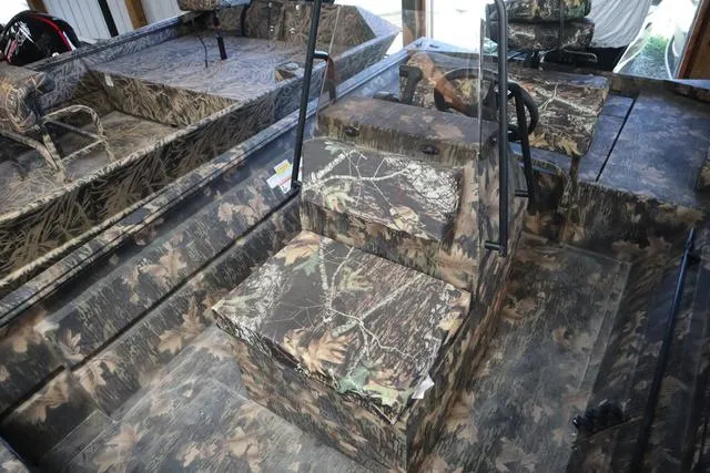 Slide: The Image of 2024 Lowe Roughneck 1860 CC boat interior with camouflage design and seating. - 5