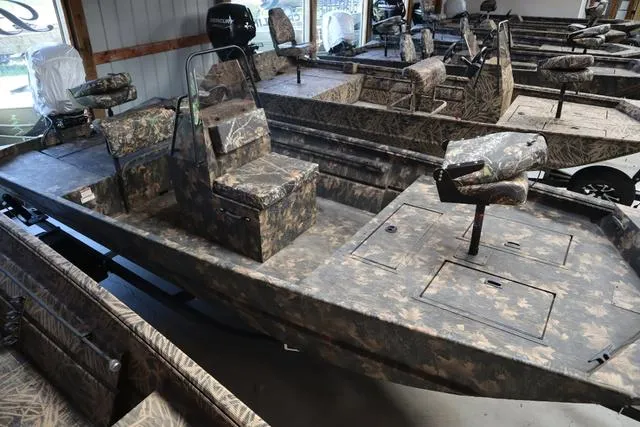 Slide: The Image of 2024 Lowe Roughneck 1860 CC boat with camouflage design in a showroom. - 8