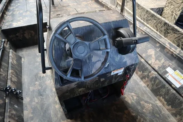 Slide: The Image of 2024 Lowe Roughneck 1860 CC boat steering console with camouflage design. - 9