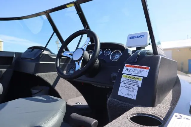 Slide: The Image of 2022 Lowe FS 1700 Fish & Ski boat interior with steering wheel and dashboard. - 5