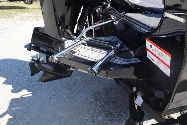 Slide: The Image of 2022 Lowe FS 1700 Fish & Ski boat ladder detail, black finish, outdoor setting. - 6