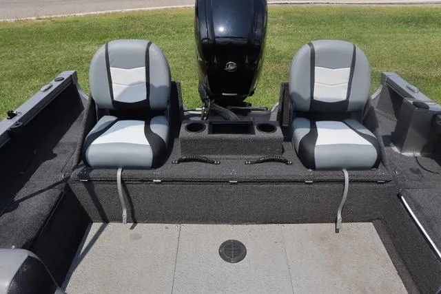 Slide: The Image of 2016 Lowe FM 1710 Pro WT boat interior with two seats and motor. - 3