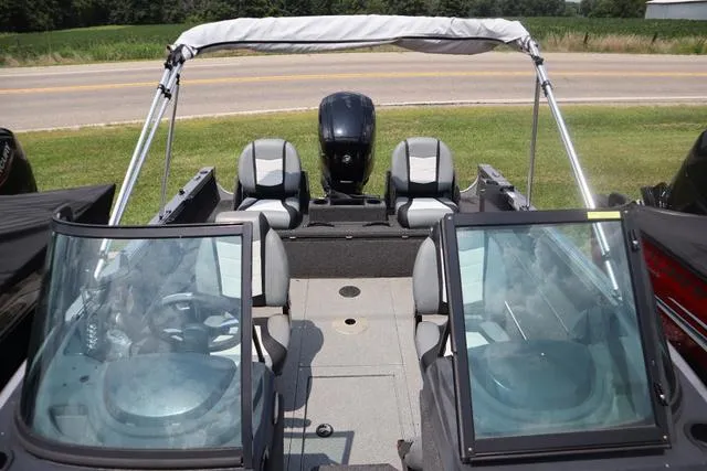 Slide: The Image of 2016 Lowe FM 1710 Pro WT boat interior with seating and windshield. - 4