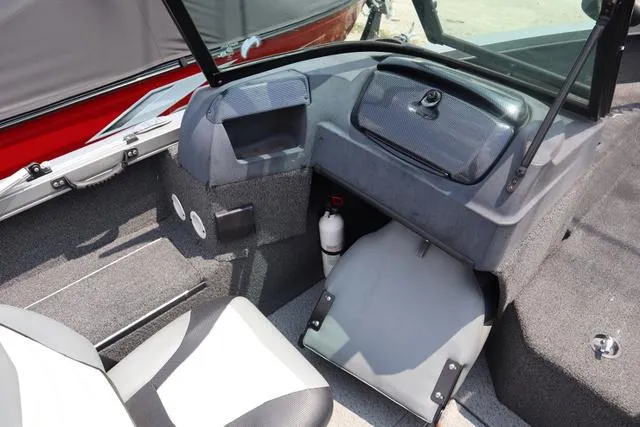 Slide: The Image of Interior of a 2016 Lowe FM 1710 Pro WT boat, featuring seating and storage compartments. - 7