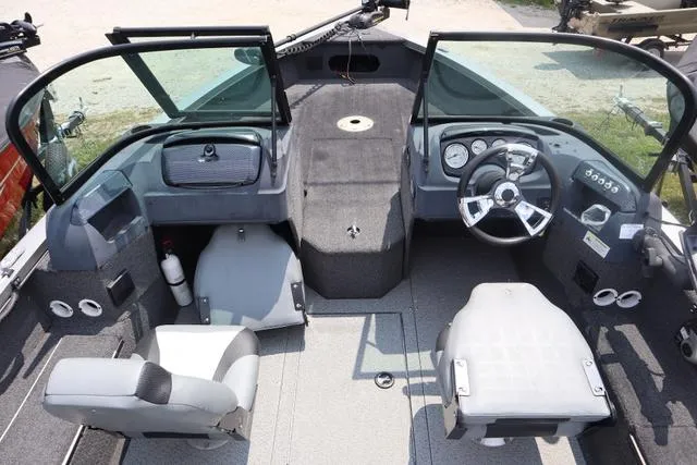 Slide: The Image of 2016 Lowe FM 1710 Pro WT boat interior with steering wheel and seating. - 9
