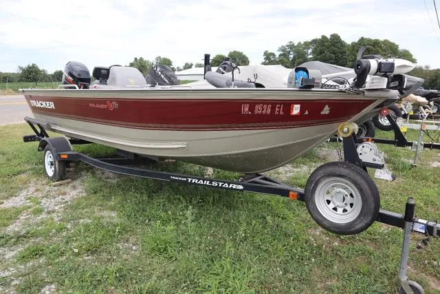 Slide: The Image of 1998 Tracker Pro Angler V16 SC boat on trailer, red and beige, parked on grass. - 3