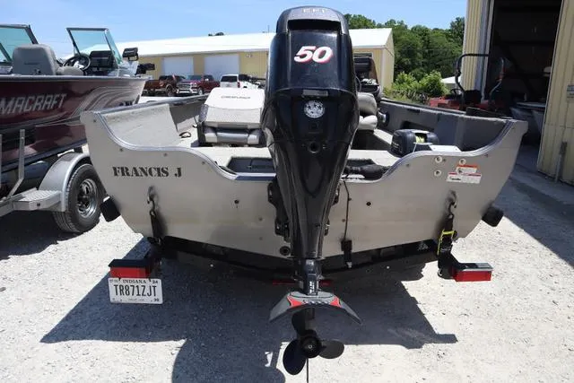 Slide: The Image of 2008 Crestliner 1600 FISH HAWK SC boat with 50 HP outboard motor, parked outdoors. - 4