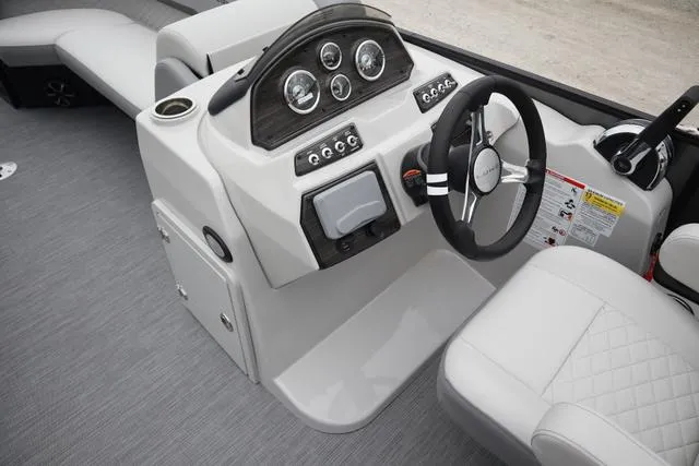 Slide: The Image of 2024 Lowe SS 230 DL boat dashboard with steering wheel and gauges. - 3