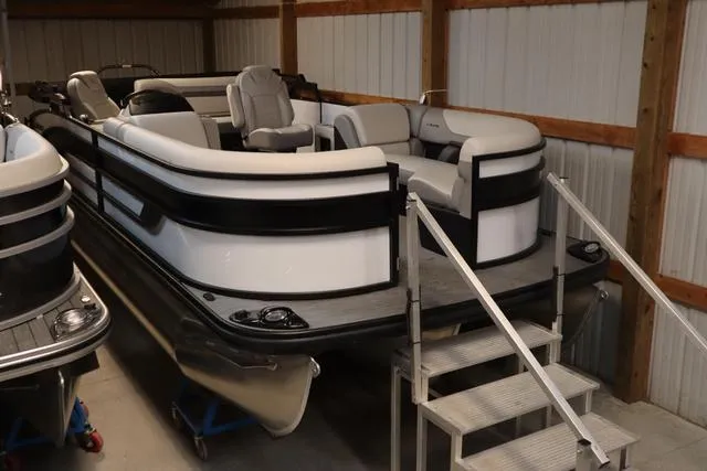 Slide: The Image of 2024 Lowe SS 230 DL Triple Tube pontoon boat in storage facility. - 6