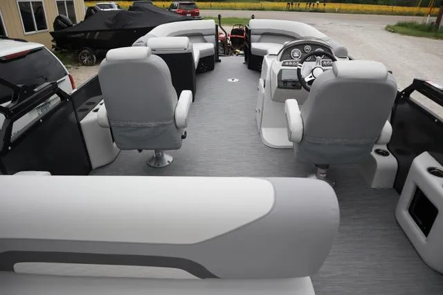 Slide: The Image of 2024 Lowe SS 230 DL Triple Tube Package boat interior with gray seating and steering console. - 8