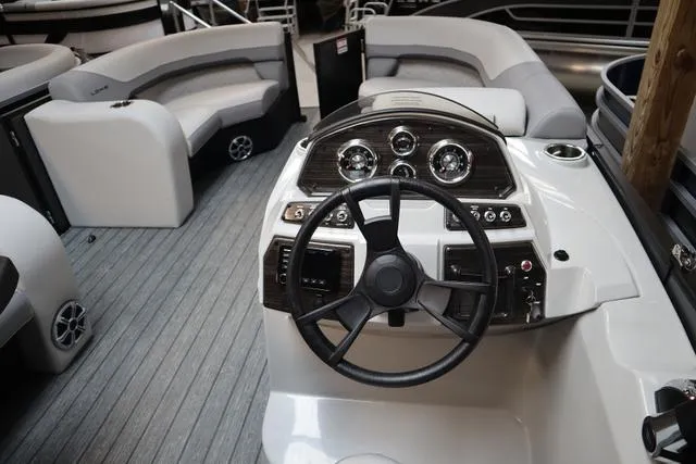 Slide: The Image of 2023 Lowe SS 210 Triple Tube Package boat interior with steering wheel and seating. - 4