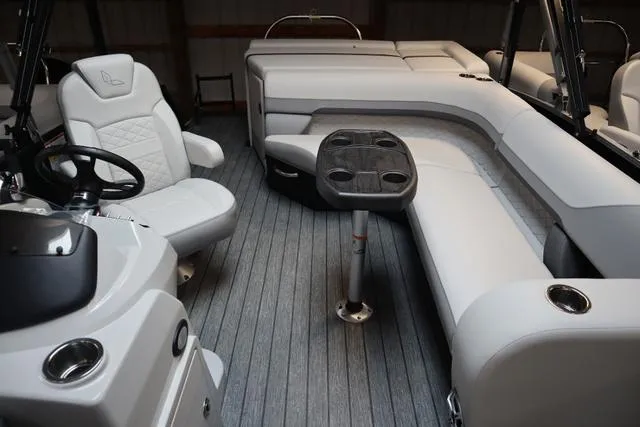 Slide: The Image of 2023 Lowe SS 210 Triple Tube Package interior with plush seating and modern helm. - 5