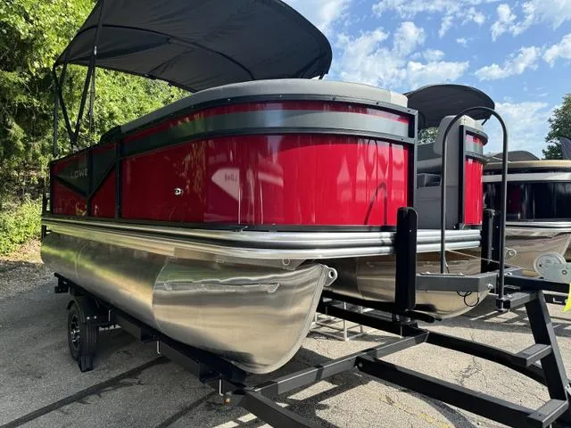 Slide: The Image of 2025 Lowe LS 170 pontoon boat with red exterior on a trailer. - 2